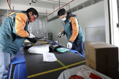 In China, if You’ve Got Mail, It Might Arrive With a Whiff of Sanitizer and a Covid-19 Test