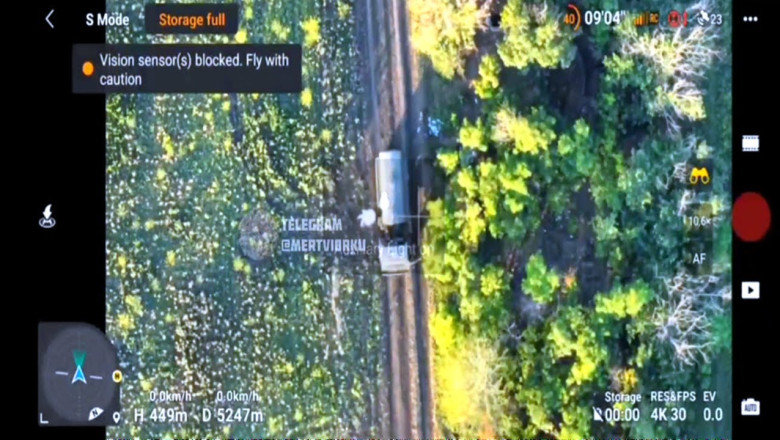 Russian troops beside a building and an armoured vehicle targeted by UAVs dropped VOG bullets.