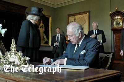 King Charles III signs Hillsborough Castle visitors book with leaking pen during Belfast trip