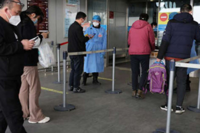 China cuts quarantine time for international travelers by two days